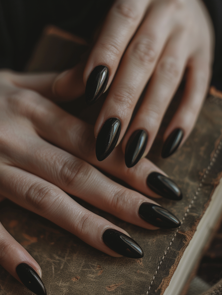 Capture a photorealistic image of sophisticated and bold black nails, meticulously manicured and painted with a glossy finish that reflects the surrounding light. The focus is on a hand casually resting on a matte, leather-bound journal, the texture of the leather contrasting with the sleekness of the nails. The scene is bathed in natural light filtered through a nearby window, casting soft shadows and highlighting the subtle curvature of the fingers and the sheen on the nails. Utilize a Canon EOS-1D X Mark III, with a 50mm f/1.2 lens, to achieve a shallow depth of field, putting the nails in sharp focus while softly blurring the background. This setup ensures high detail and a realistic grain texture reminiscent of editorial beauty shots. Emphasize the balance between the boldness of the nails and the subtlety of natural lighting to evoke a feeling of elegance and strength.